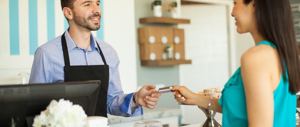 woman-using-gift-card-at-small-cafe