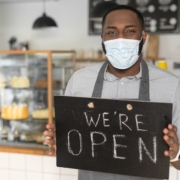 restaurant-worker-wearing-mask-with-open-sign