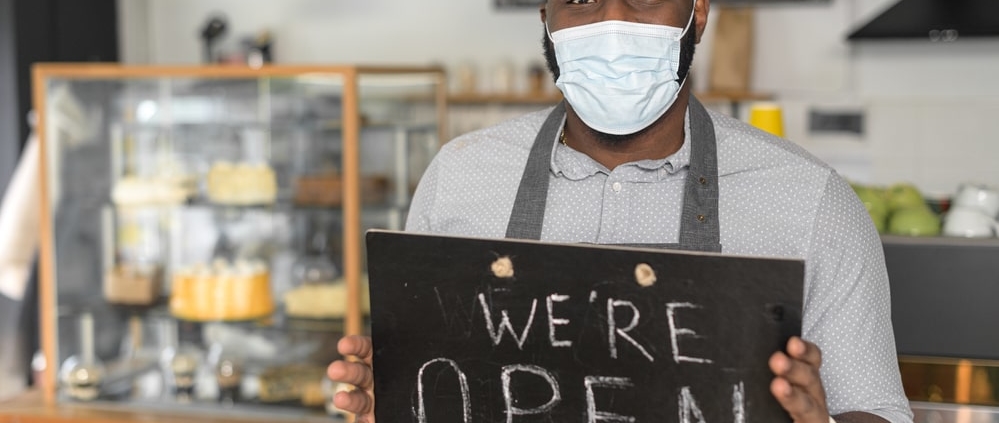 restaurant-worker-wearing-mask-with-open-sign