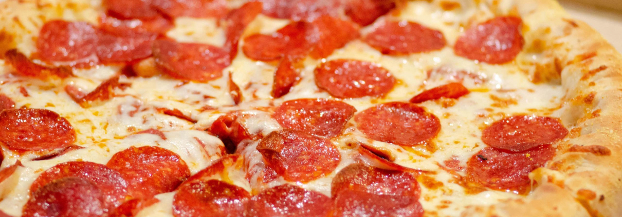 A close-up of a pepperoni pizza. It looks hot, and it looks ready.