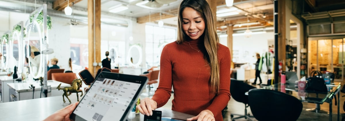 Woman paying with Gift Card at Salon