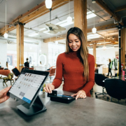 Woman paying with Gift Card at Salon