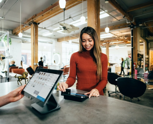 Woman paying with Gift Card at Salon