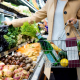 Lady picking out vegetables at grocery store