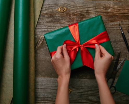 Tying bow on gift